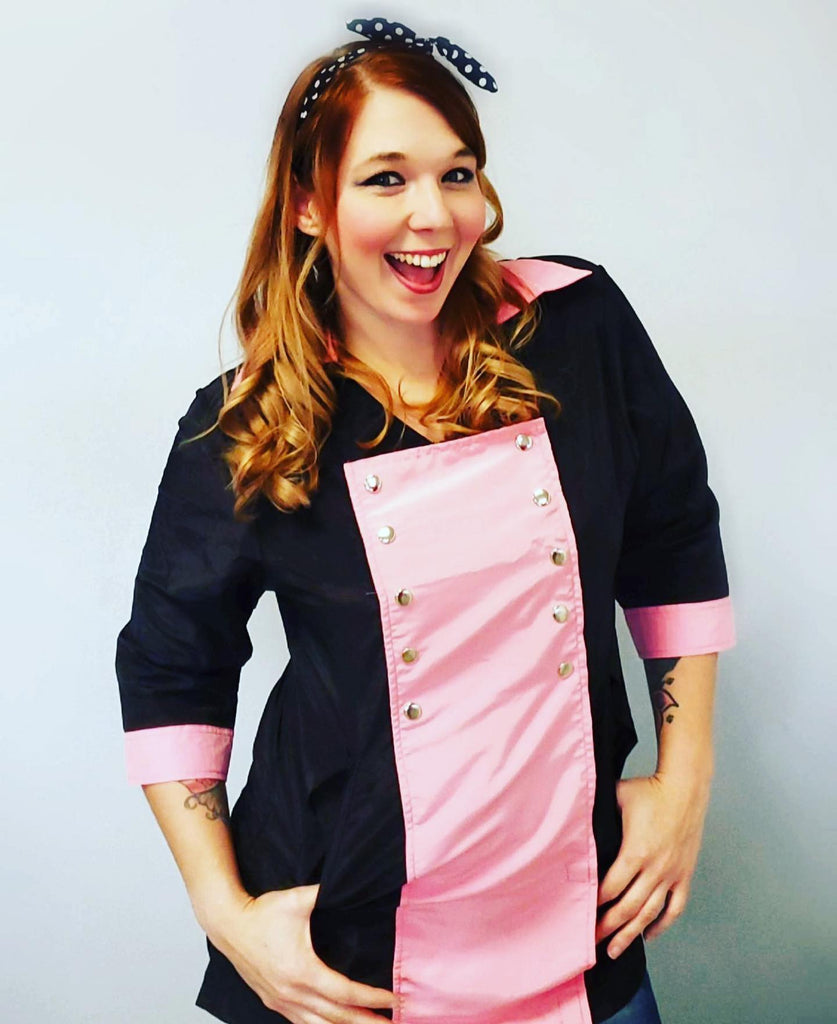 Pet stylist showing off the Pink and Black Military grooming smock